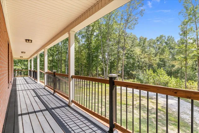 a view of balcony with wooden floor and fence