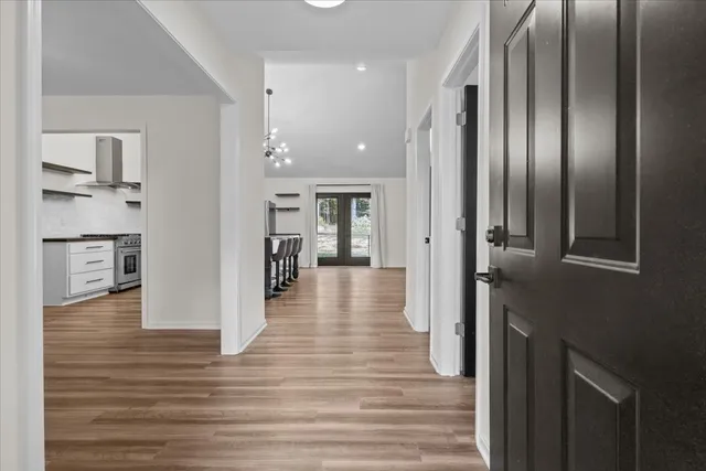 a view of a hallway with wooden floor