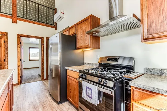 a kitchen with wooden cabinets and a stove top oven