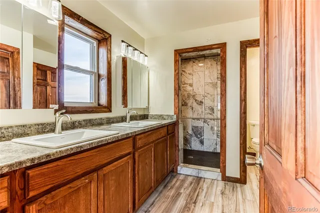 a bathroom with a double vanity sink and a mirror
