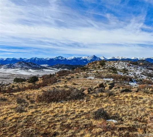 a view of a yard with wooden fence