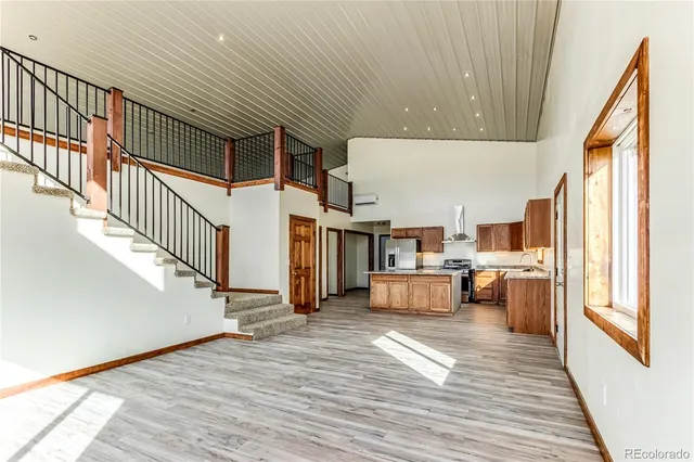 a view of a kitchen with furniture and wooden floor