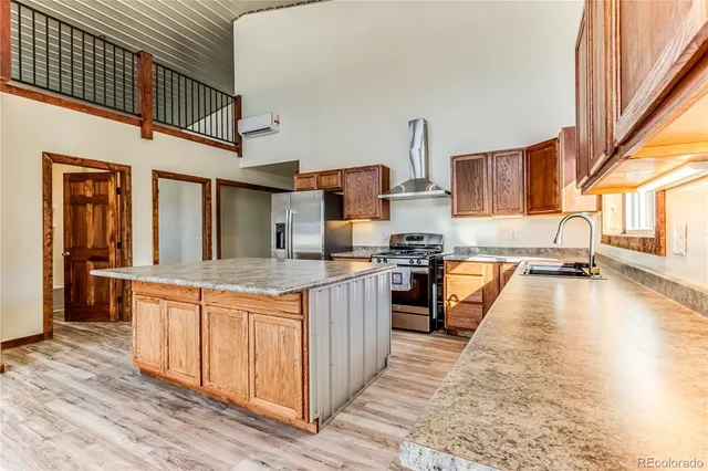 a kitchen with stainless steel appliances granite countertop a stove and a sink