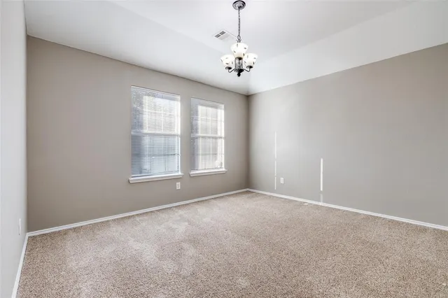 a view of an empty room with a window and fireplace
