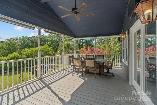 a view of a chairs and table in patio with a fireplace