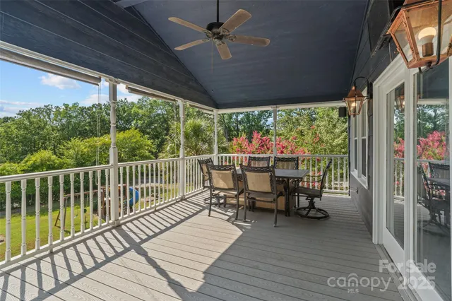 a view of a chairs and table in patio with a fireplace