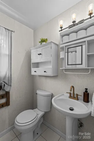 a bathroom with a sink toilet and mirror