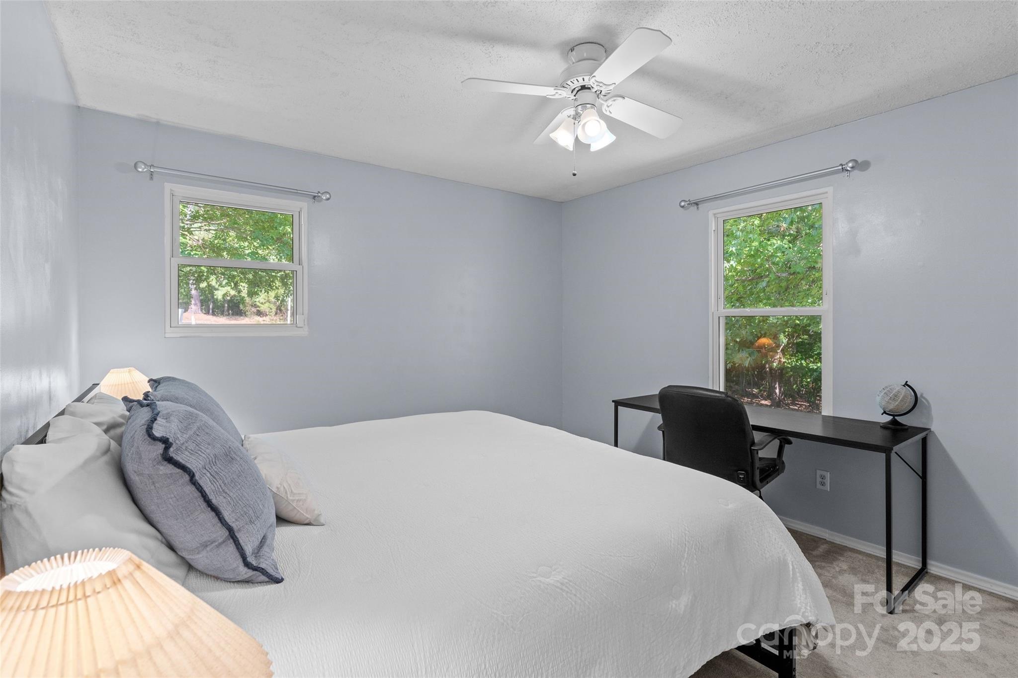 335 Carroll Cove Clover, SC 29710 - Photo 18 of 29 a bedroom with a bed and a chandelier