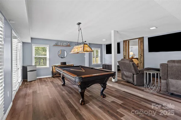 a living room with furniture a rug and a flat screen tv