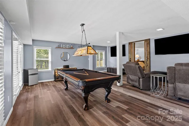 a living room with furniture a rug and a flat screen tv