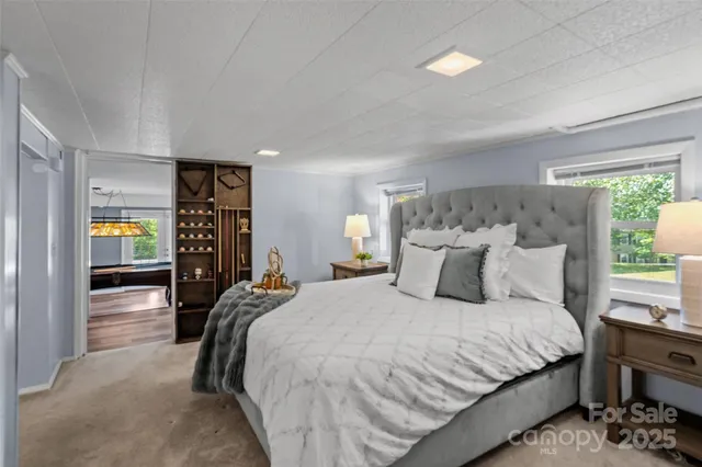 a bedroom with a large bed and a window