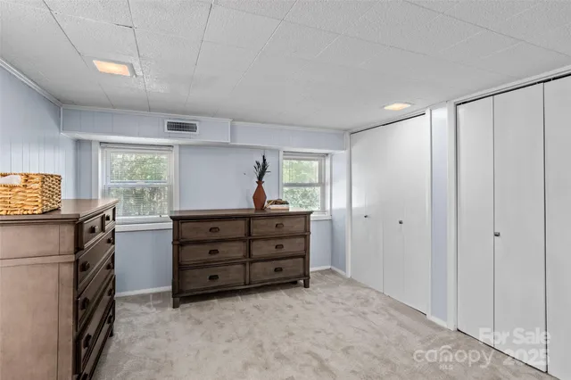 a room with a dresser and a window