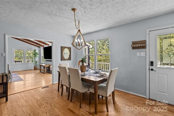 a view of a livingroom with furniture window and wooden floor