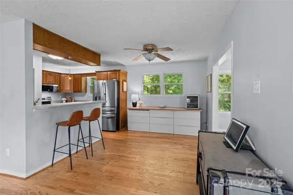 a kitchen with a table chairs refrigerator and cabinets