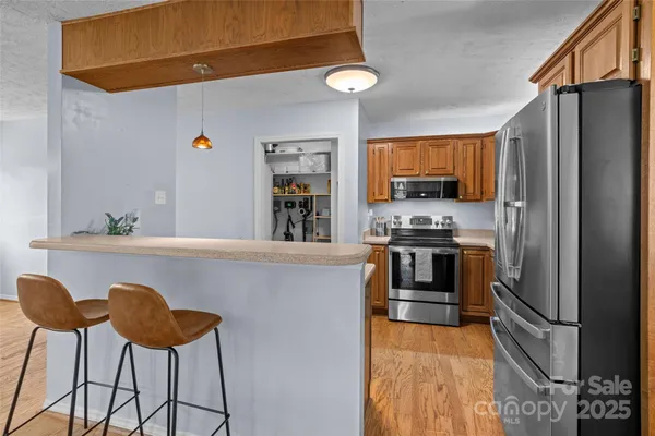 a kitchen with stainless steel appliances a stove a sink and a refrigerator