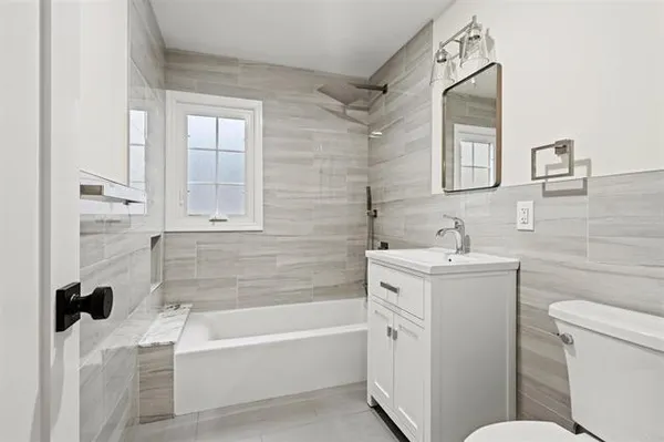 a bathroom with a sink toilet and shower