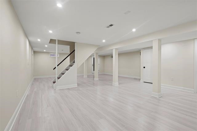 238 Springfield Avenue, Unit 1 Rutherford, NJ 07070 - Photo 13 of 33 a view of an empty room with wooden floor and stairs