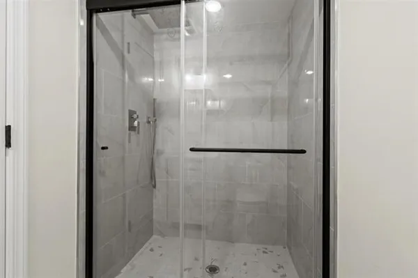 a bathroom with a glass shower door