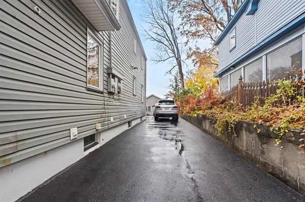 a view of a house with a yard and a street