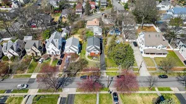 an aerial view of residential houses with outdoor space