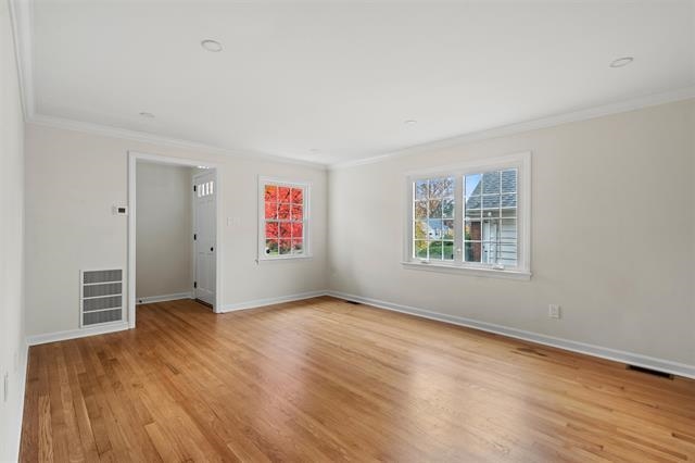 238 Springfield Avenue, Unit 1 Rutherford, NJ 07070 - Photo 6 of 33 an empty room with wooden floor and windows