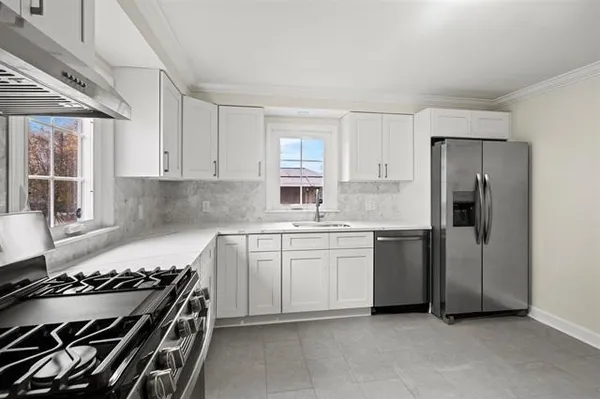 a kitchen with a stove and a refrigerator