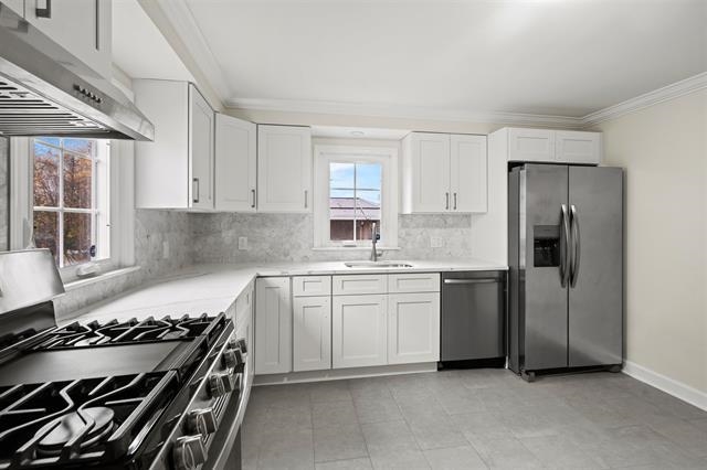 238 Springfield Avenue, Unit 1 Rutherford, NJ 07070 - Photo 8 of 33 a kitchen with a stove and a refrigerator
