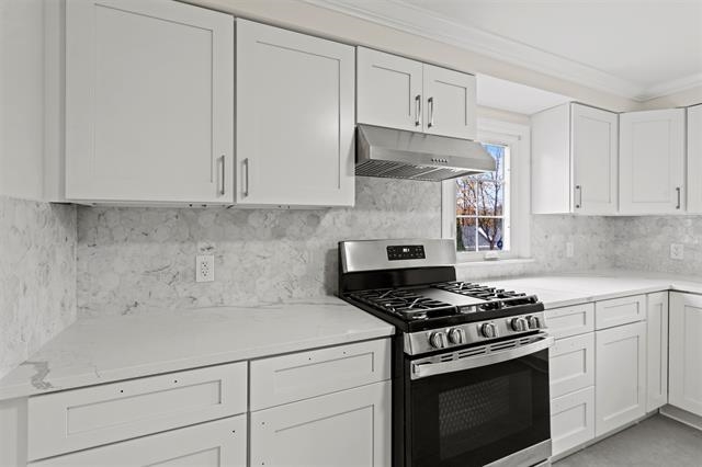 238 Springfield Avenue, Unit 1 Rutherford, NJ 07070 - Photo 9 of 33 a kitchen with white cabinets and appliances