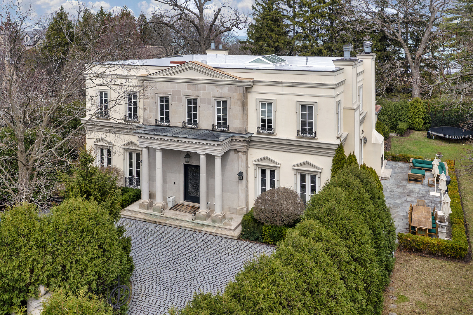 977 Sheridan Road Winnetka, IL 60093 - Photo 1 of 4 a front view of a house with a garden