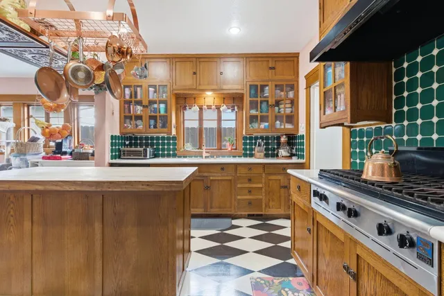 a kitchen with stainless steel appliances a stove a sink and a cabinets