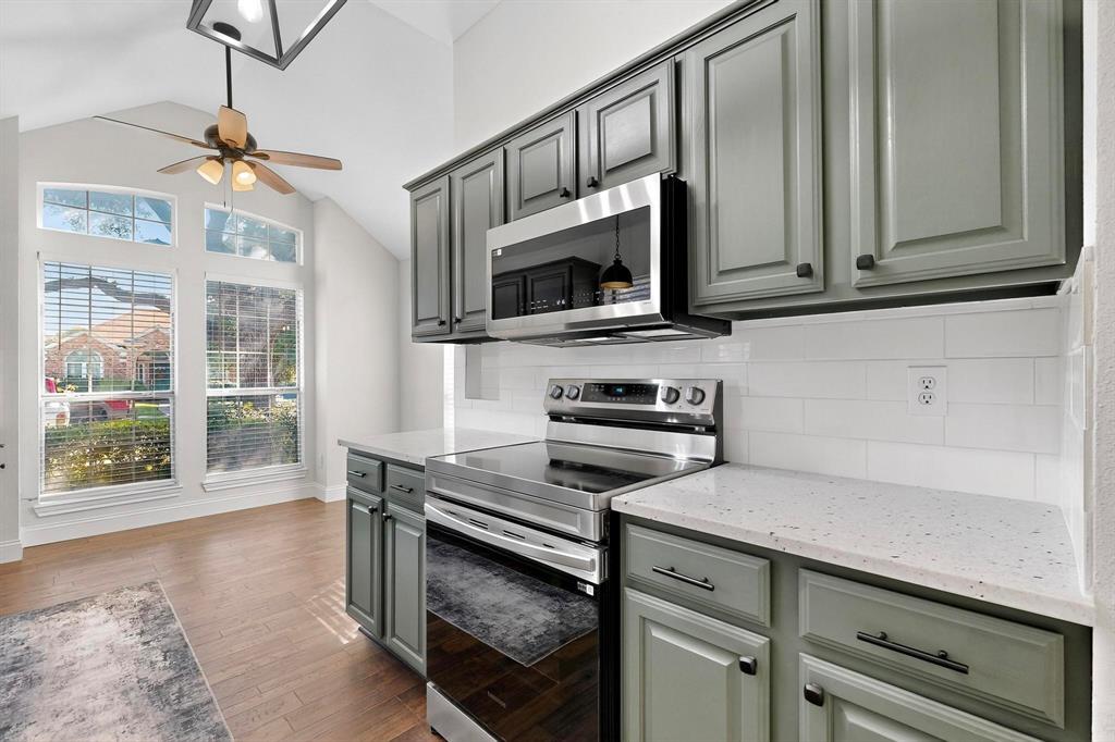 2601 Daisy Lane Rowlett, TX 75089 - Photo 14 of 36 a kitchen with stainless steel appliances a stove microwave and cabinets