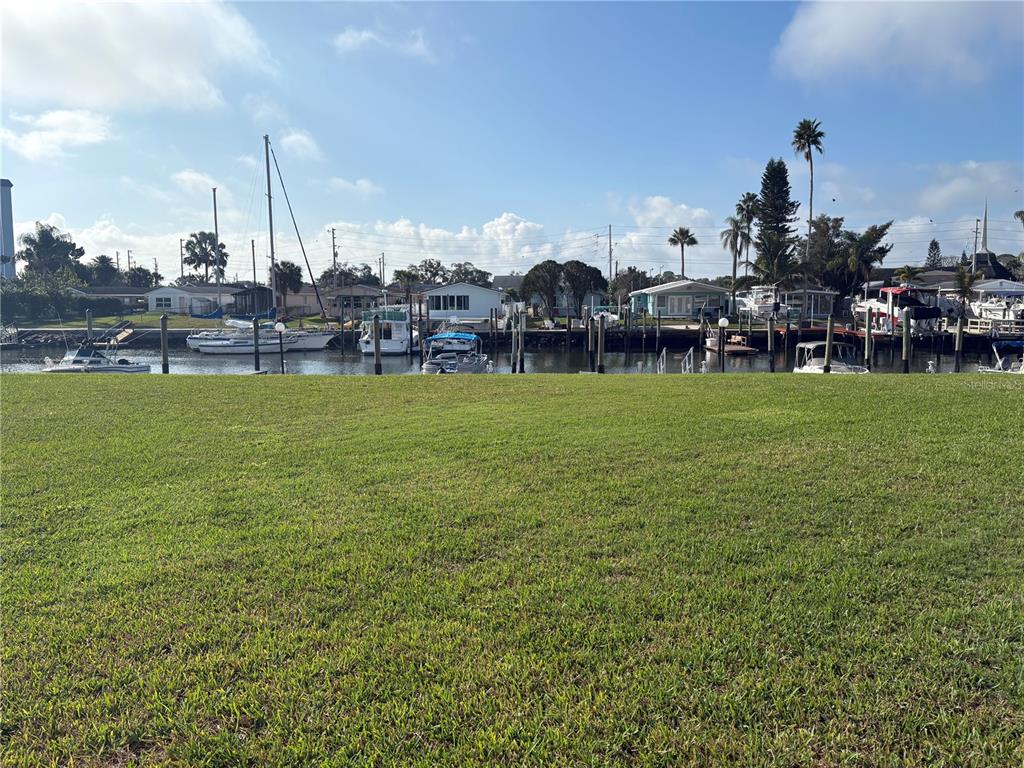 5157 Silent Loop, Unit 115 New Port Richey, FL 34652 - Photo 11 of 18 a view of a fountain in front of a house with a big yard