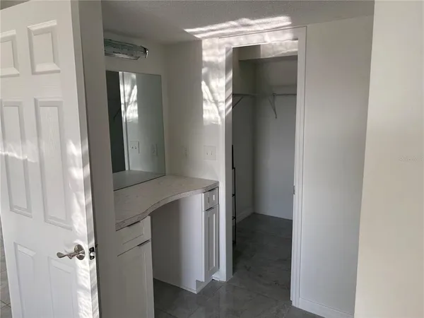 a bathroom with a granite countertop sink toilet and bathtub
