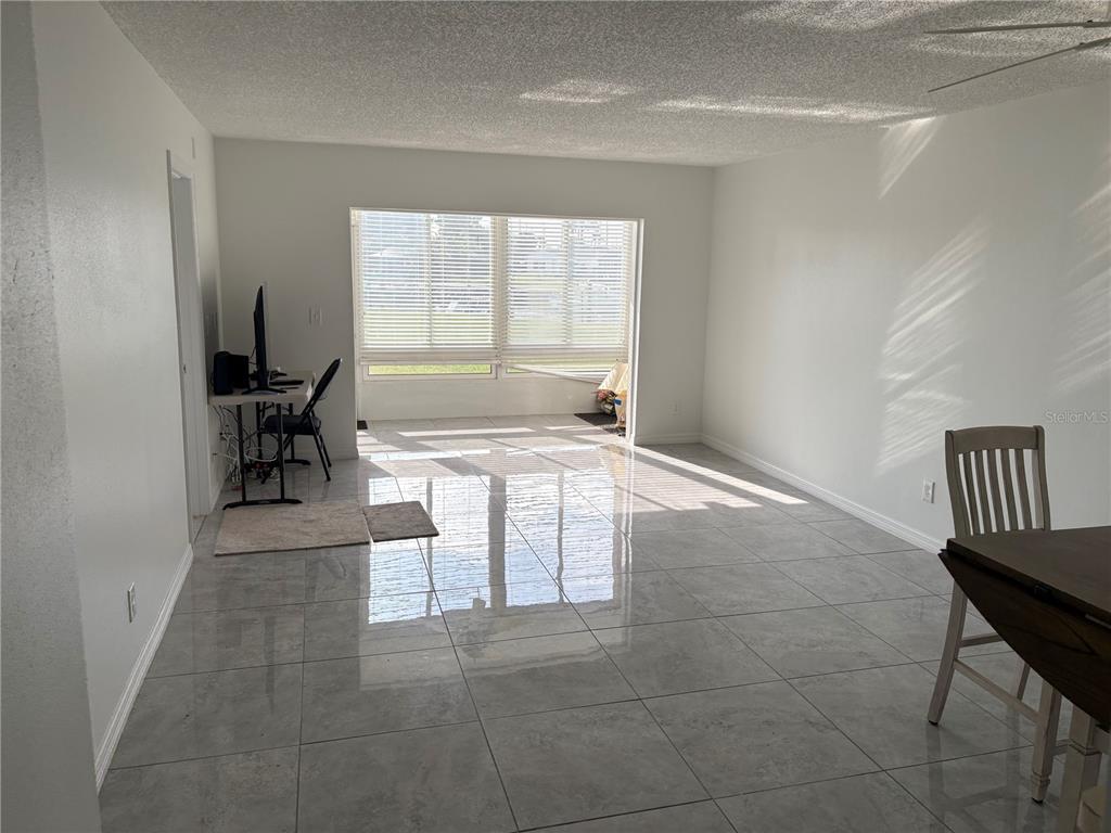 5157 Silent Loop, Unit 115 New Port Richey, FL 34652 - Photo 8 of 18 a living room with furniture and a window
