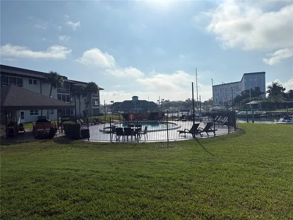 a view of a fountain in front of a house with a big yard