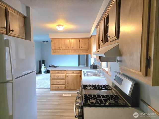 a kitchen with stainless steel appliances granite countertop a stove and a refrigerator