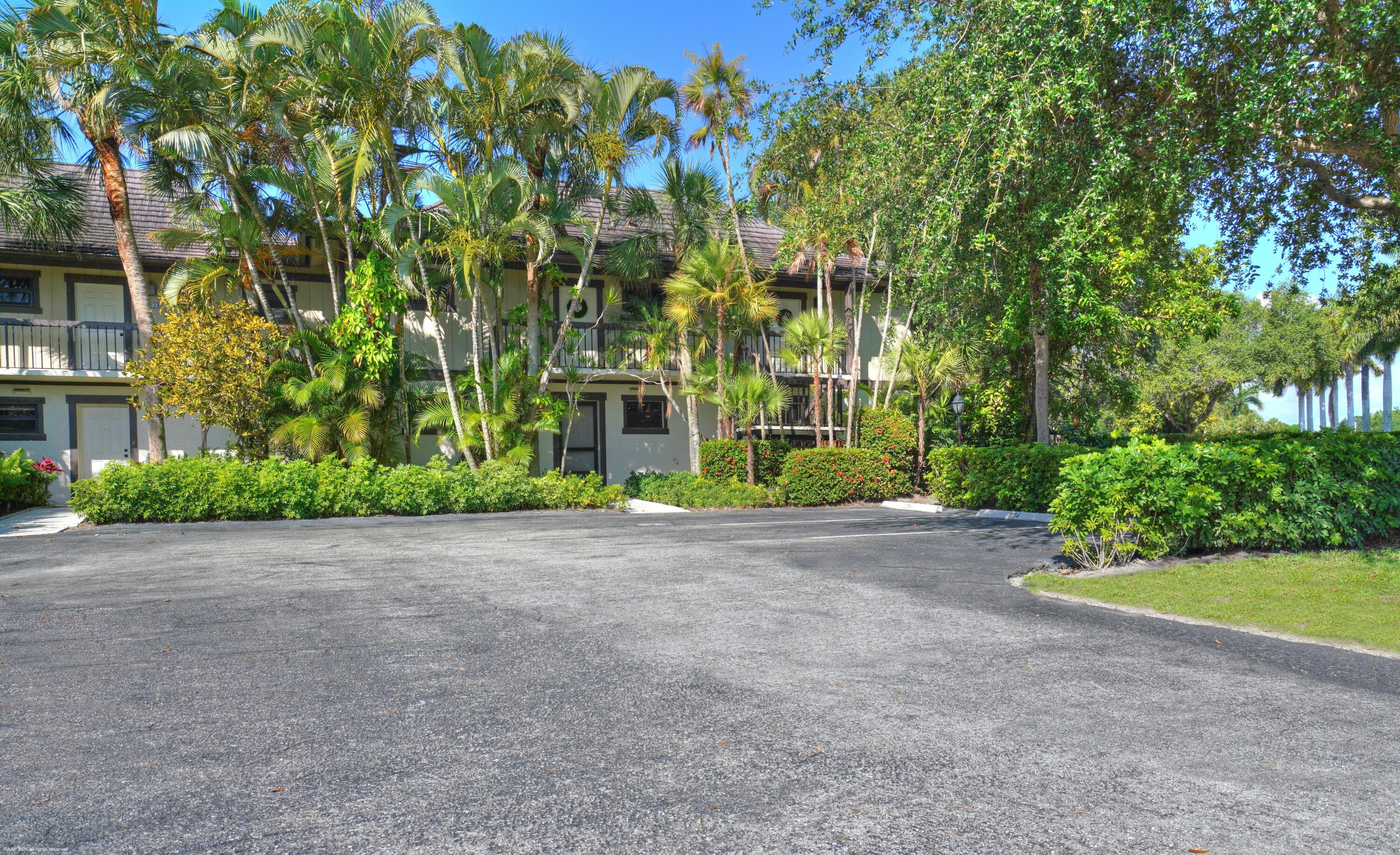 13334 Polo Club Road, Unit 234 Wellington, FL 33414 - Photo 40 of 41 a view of a house with plants and large trees