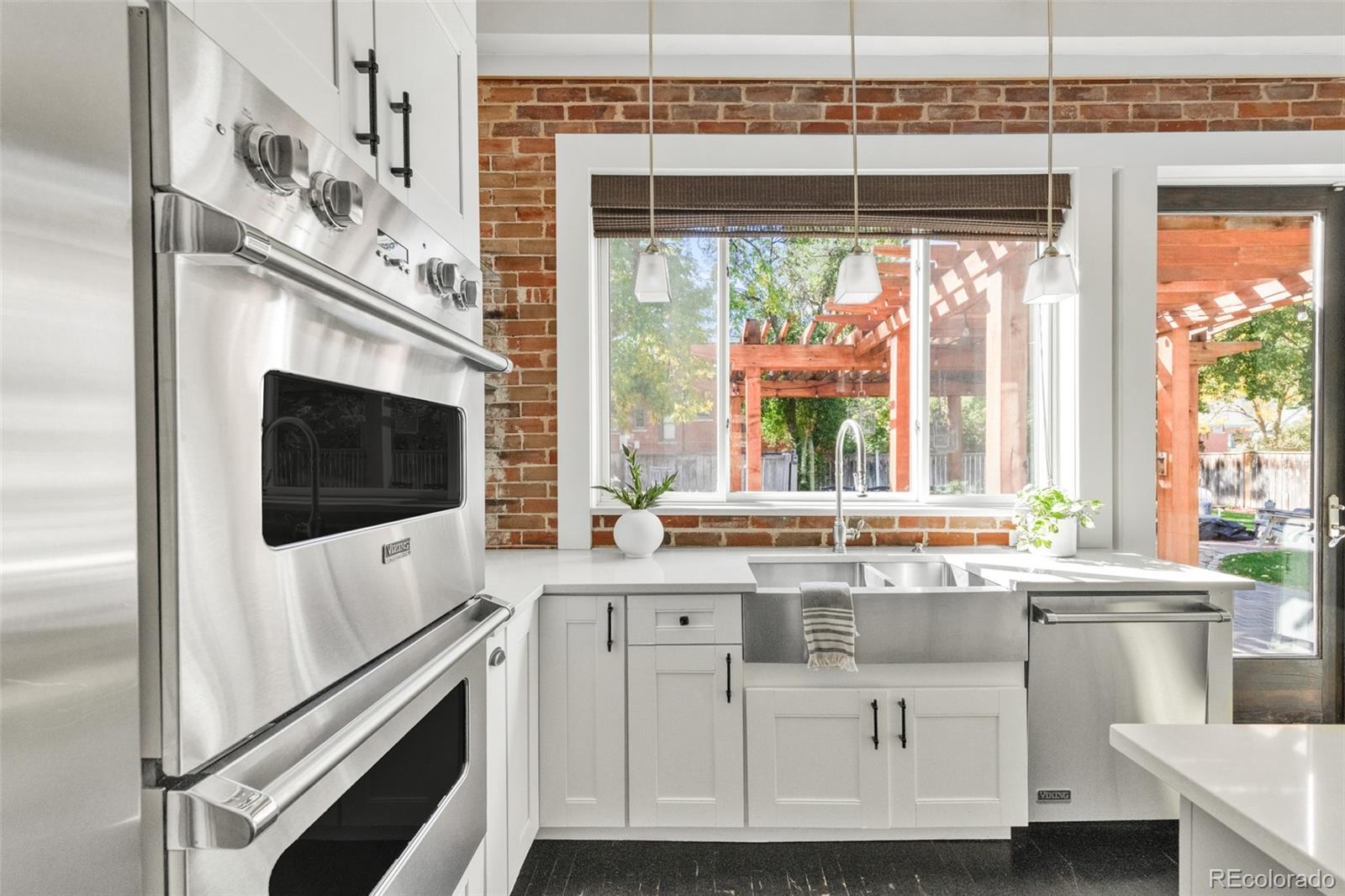 3659 Alcott Street Denver, CO 80211 - Photo 12 of 49 a kitchen with stainless steel appliances cabinets a large window and a sink