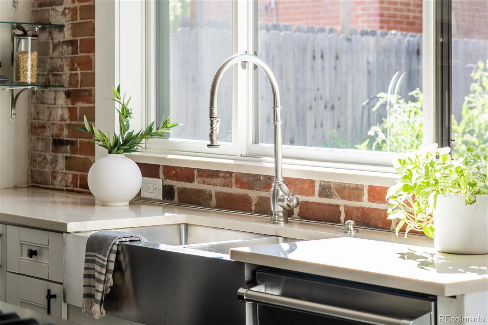 3659 Alcott Street Denver, CO 80211 - Photo 13 of 49 a kitchen with a sink and a potted plant