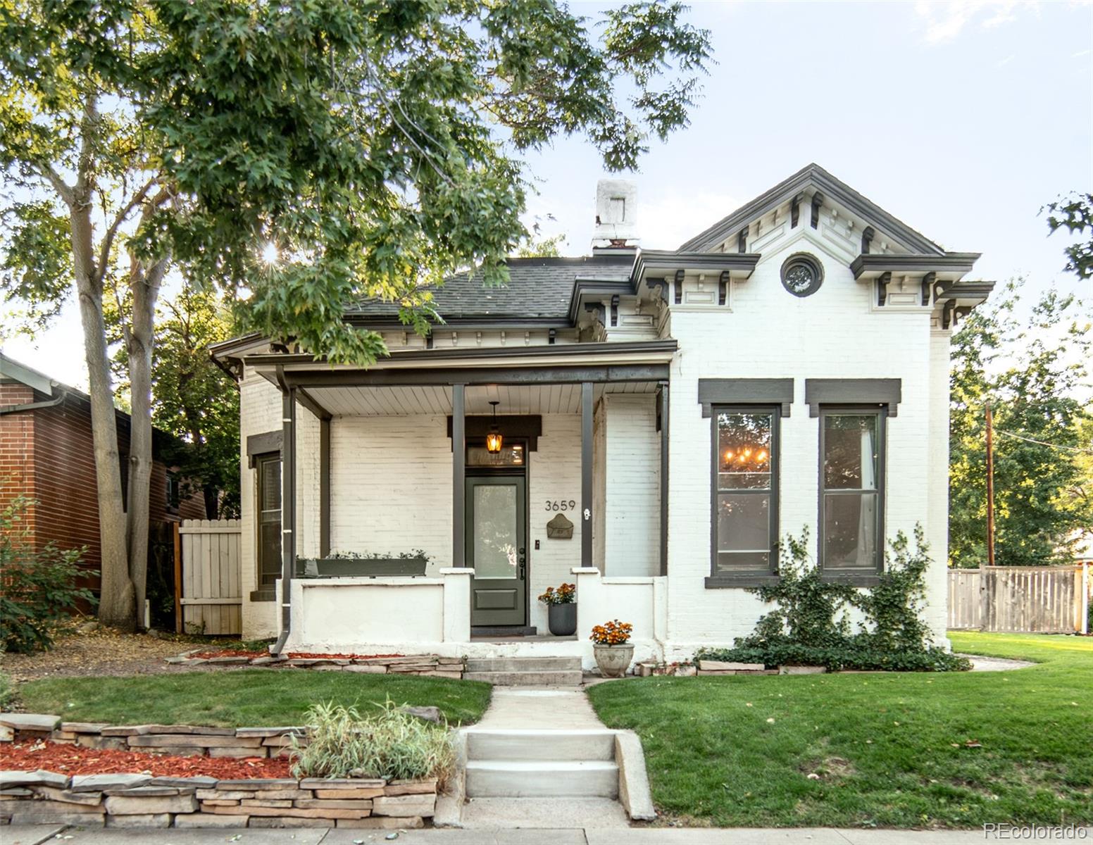 3659 Alcott Street Denver, CO 80211 - Photo 2 of 49 a front view of a house with a yard