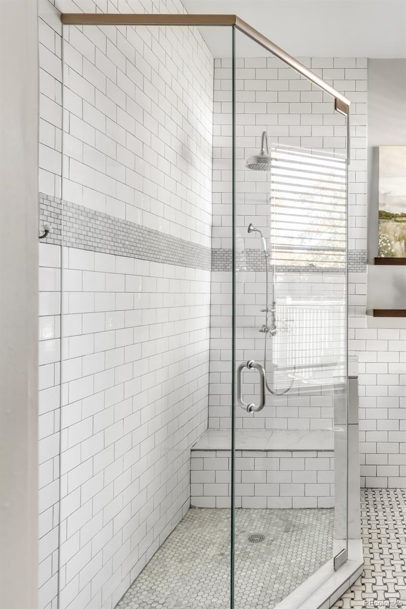 3659 Alcott Street Denver, CO 80211 - Photo 36 of 49 a bathroom with a glass shower door