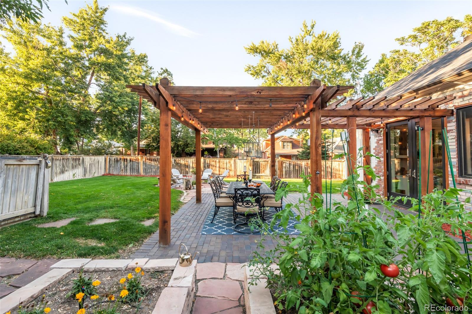 3659 Alcott Street Denver, CO 80211 - Photo 38 of 49 a patio with table and chairs and potted plants