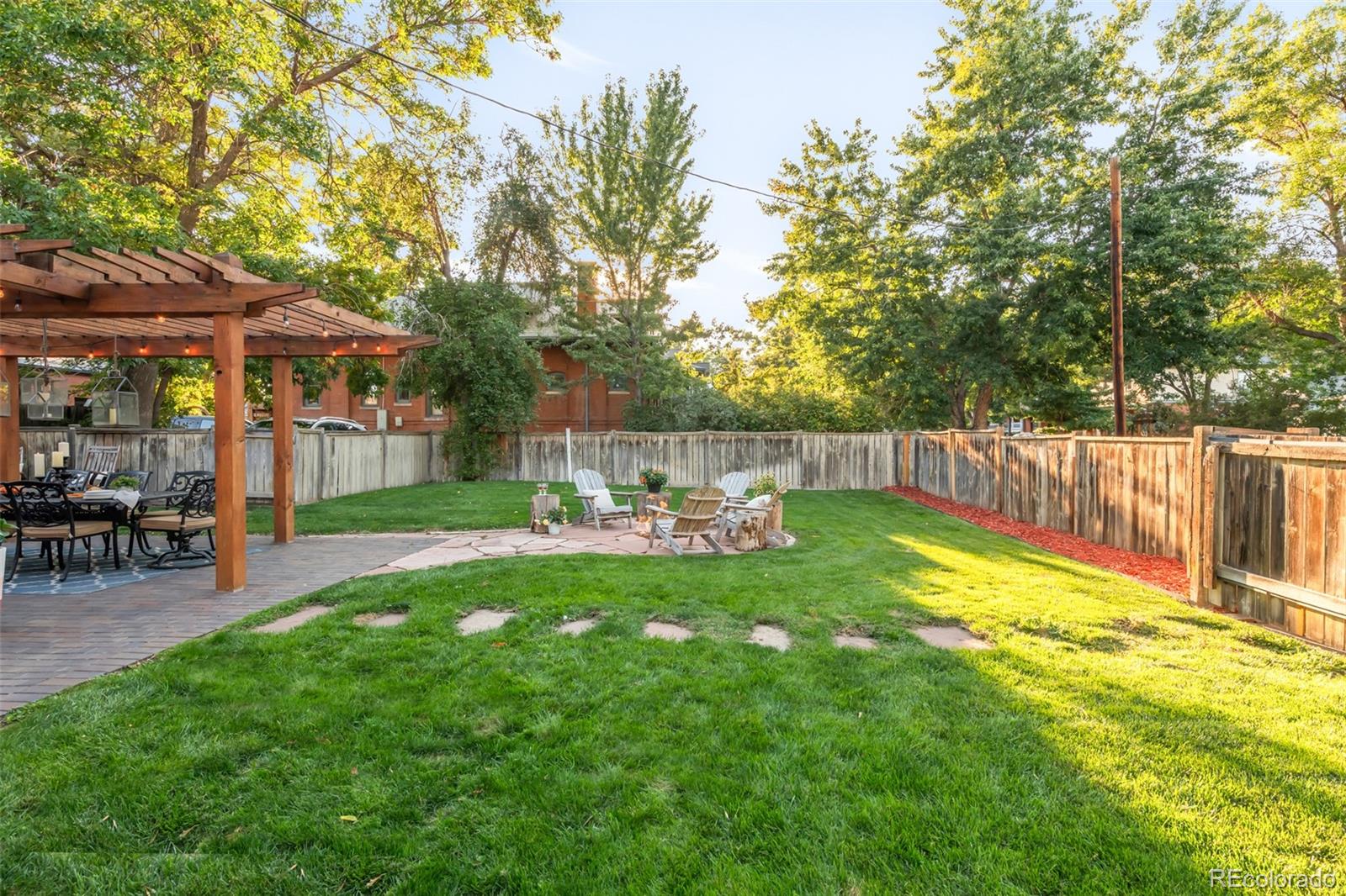 3659 Alcott Street Denver, CO 80211 - Photo 42 of 49 a view of a backyard with table and chairs under an umbrella