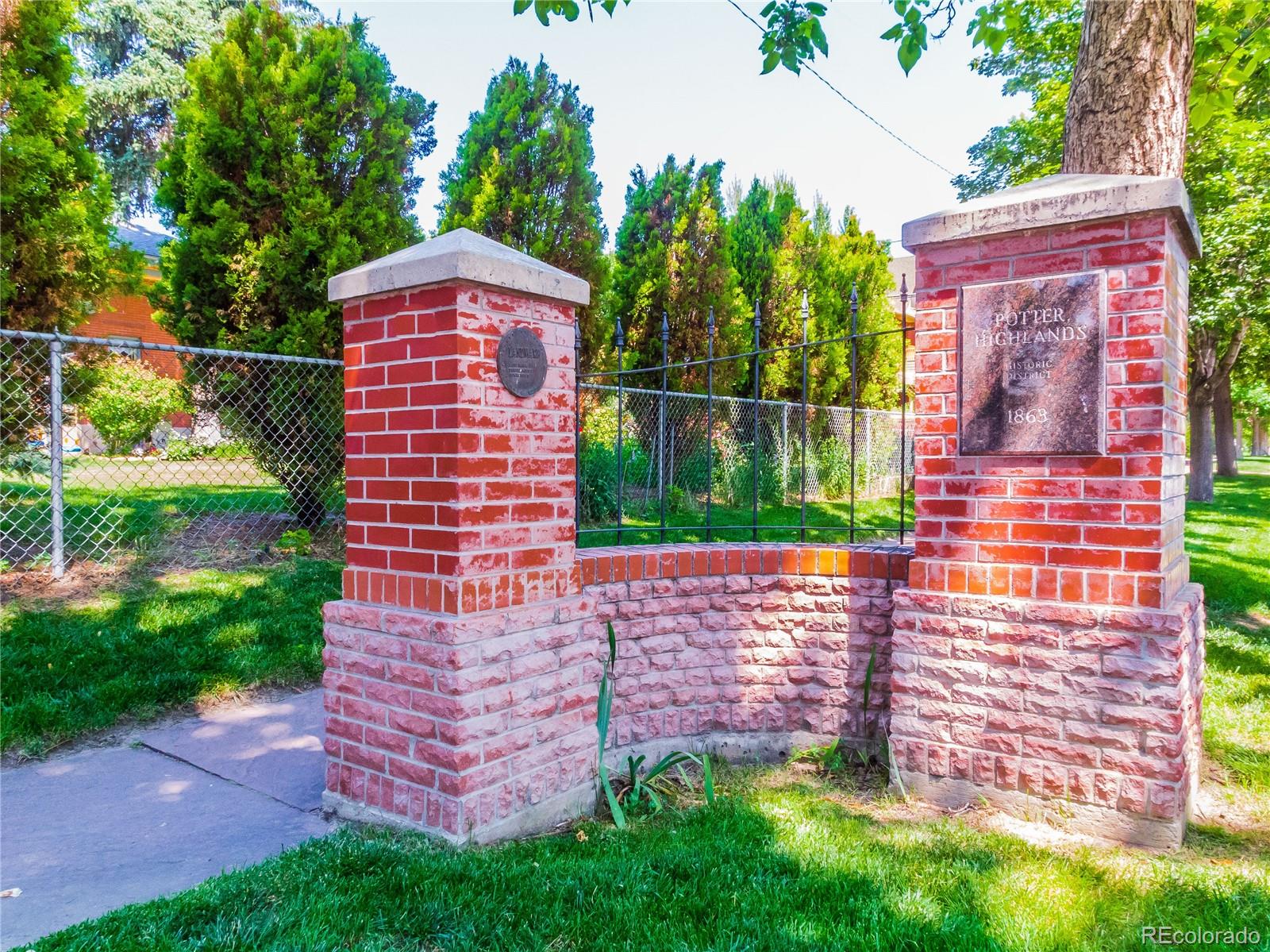 3659 Alcott Street Denver, CO 80211 - Photo 46 of 49 a view of a yard with brick wall and a large tree