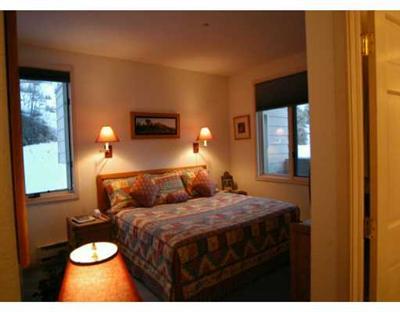 625 North Frontage Road West, Unit 44 Vail, CO 81657 - Photo 4 of 6 a bedroom with a bed and wooden floor