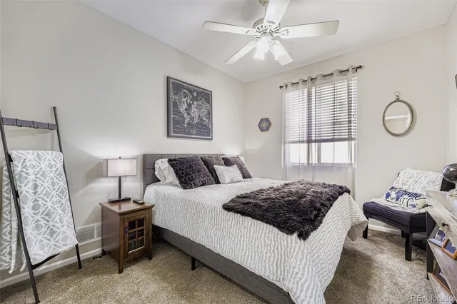 a bedroom with a bed a rug and a window