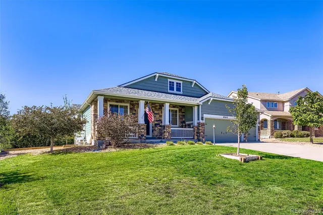a view of a house with a yard porch and sitting area