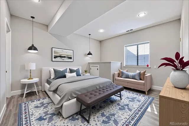 a bedroom with a bed a couch and window