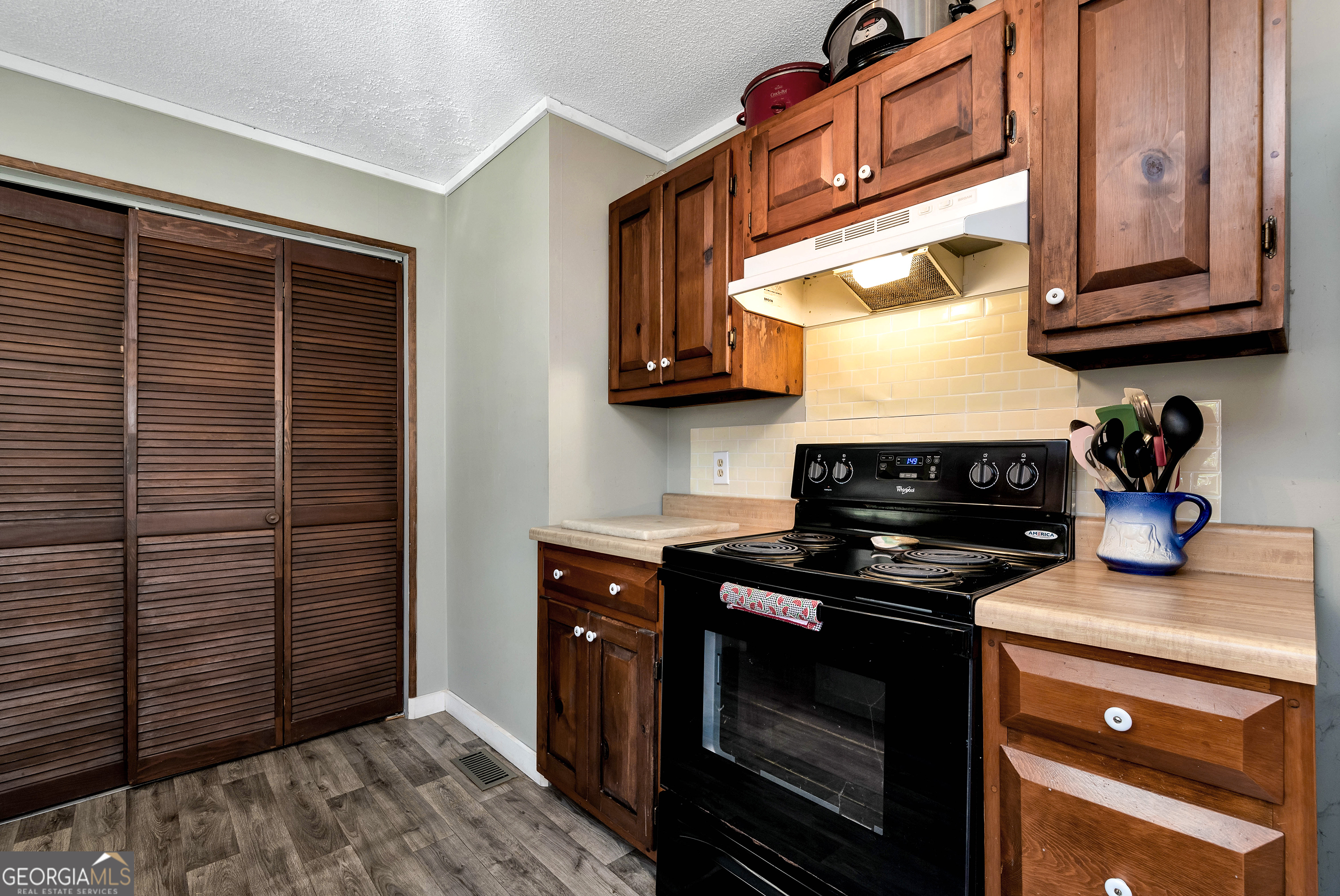 373 Jennys Cove Road Cleveland, GA 30528 - Photo 18 of 44 a kitchen with stainless steel appliances granite countertop a stove and a microwave