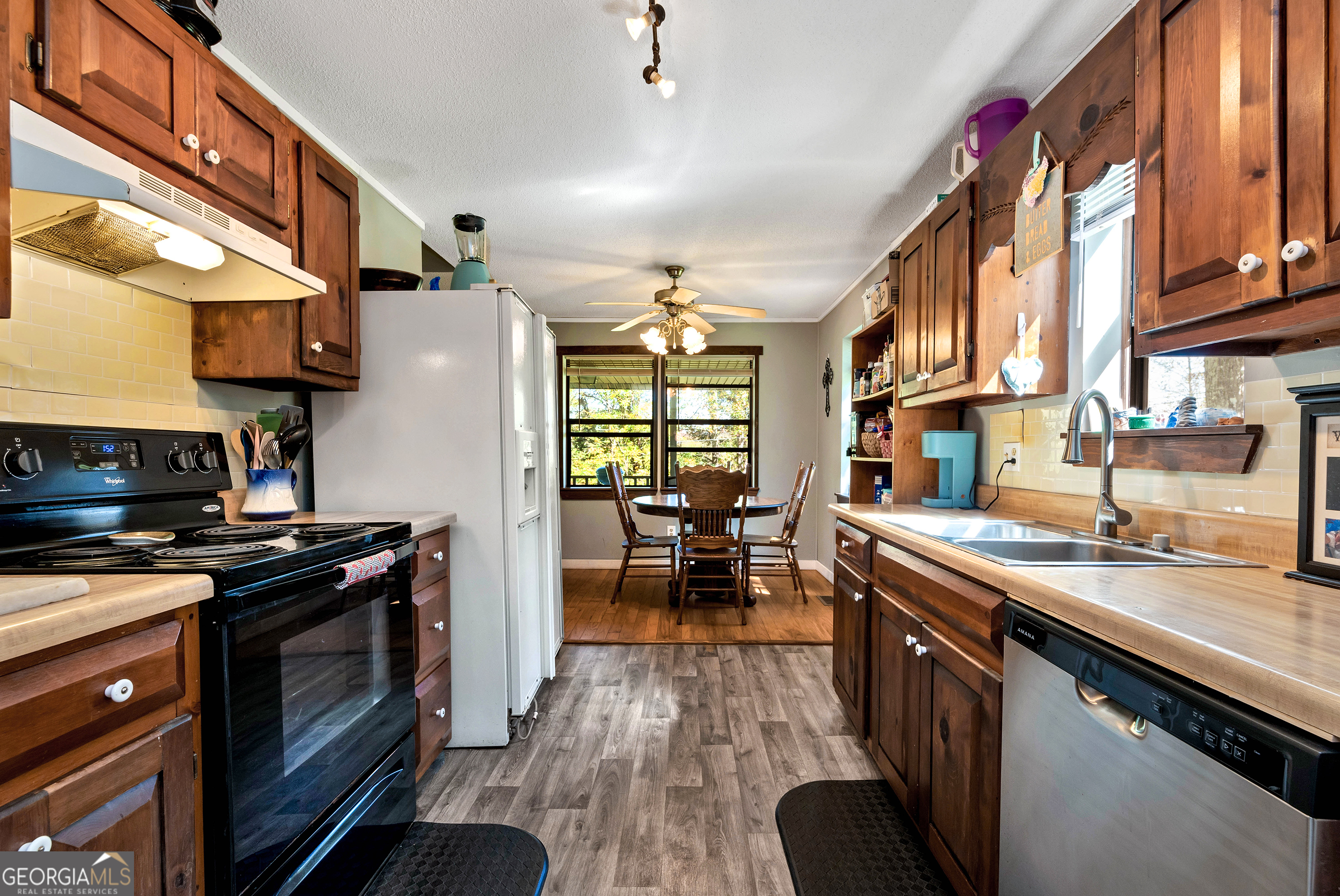 373 Jennys Cove Road Cleveland, GA 30528 - Photo 20 of 44 a kitchen with stainless steel appliances granite countertop a stove a sink dishwasher and cabinets with wooden floor